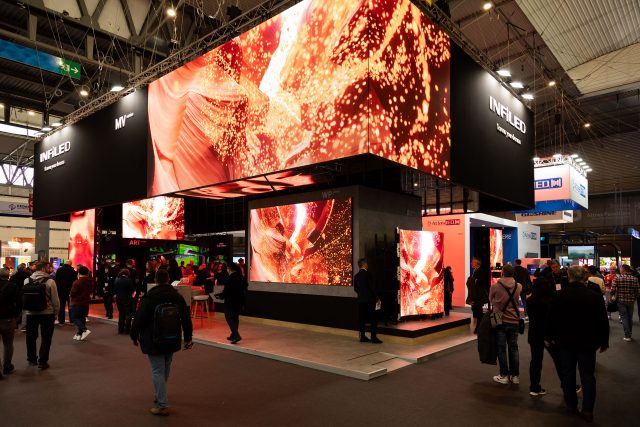 Display of Infiled LED screens at a trade fair or live event with people around