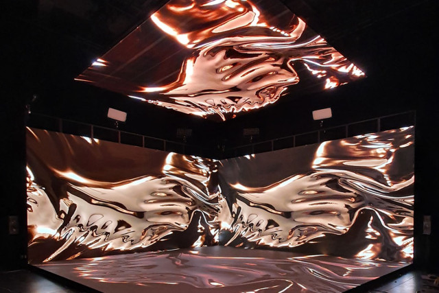 Image projected on screen with curved motifs in pink and gold