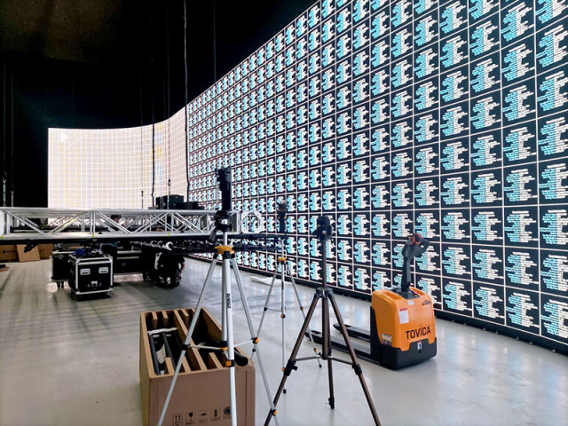 Large LED display wall setup in a studio environment with equipment in the foreground