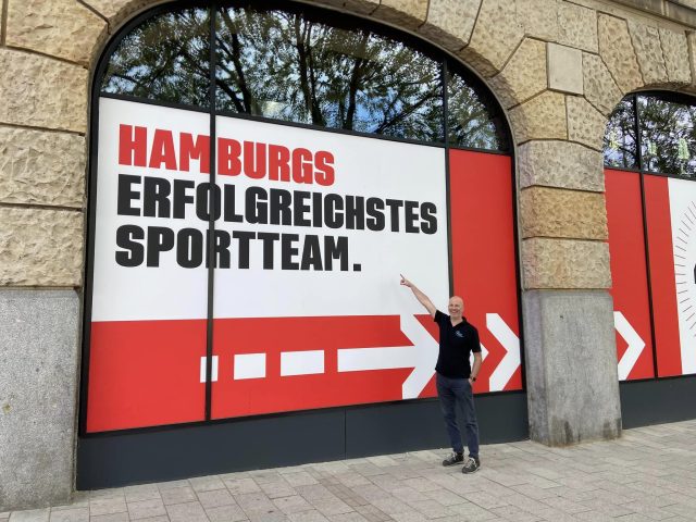 Andreas Doetkotte-Schütte, founder of Andy Mediatainment, standing before the window of the MOUZ HQ arena.