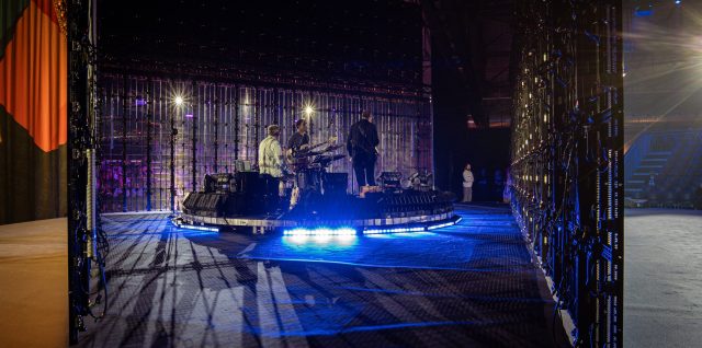 INFiLED Hololight Series transparent LED on the VOICES 2026 stage in Germany, with the band and audience visible through the open LED strips.